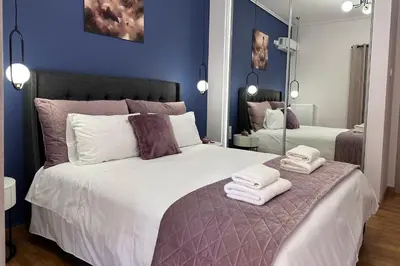 a bedroom with a large bed with towels on it at Elaia Luxury Selections Sapphire in Athens