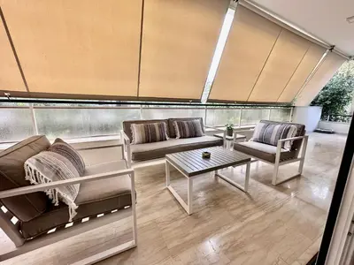 a living room with two couches and a table at Elaia Luxury Selections Sapphire in Athens