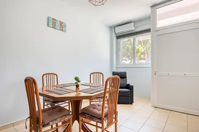 a dining room with a table and chairs at Seaside Escape Apartments - Apollon in Palaiá Fókaia