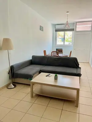 a living room with a couch and a table at Seaside Escape Apartments - Apollon in Palaiá Fókaia