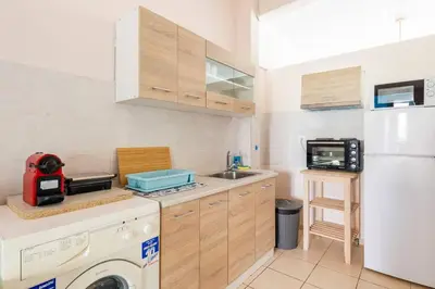 a kitchen with a refrigerator and a washing machine at Seaside Escape Apartments - Apollon in Palaiá Fókaia