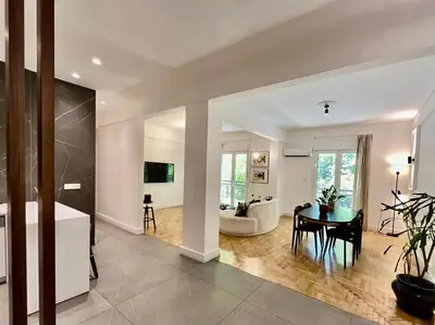 a kitchen and living room with a table and a couch at Elegant Two Bedroom Apartment a few steps from Plaka in Athens