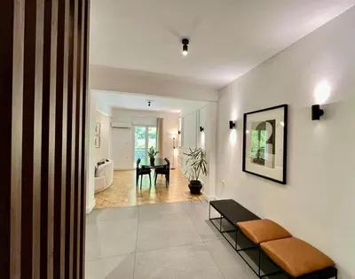 a living room with a couch and a table at Elegant Two Bedroom Apartment a few steps from Plaka in Athens