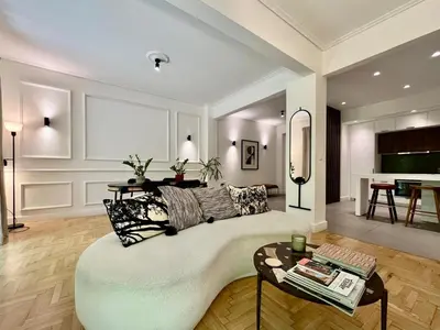a living room with a large couch and a table at Elegant Two Bedroom Apartment a few steps from Plaka in Athens
