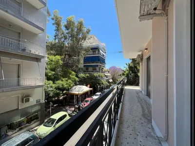 a balcony of a building with cars on a street at Elegant Two Bedroom Apartment a few steps from Plaka in Athens