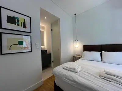 a bedroom with a white bed with towels on it at Elegant Two Bedroom Apartment a few steps from Plaka in Athens