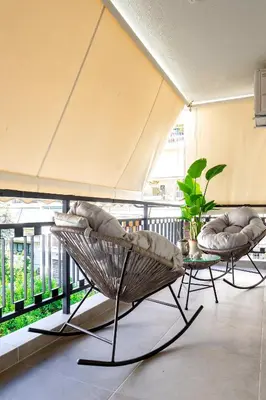 a patio with two chairs and a table on a balcony at EcoStay - Infinity business class 2BDR apartment by the sea in Alimos in Athens