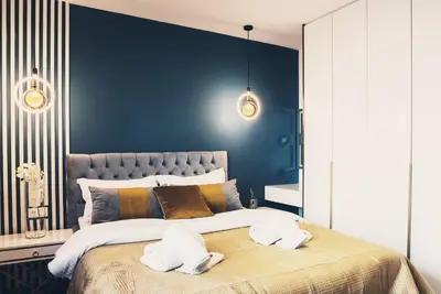 a bedroom with a large bed with two towels on it at EcoStay - Infinity business class 2BDR apartment by the sea in Alimos in Athens