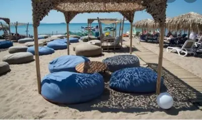 a group of blue bean bags on the beach at EcoStay - Infinity business class 2BDR apartment by the sea in Alimos in Athens