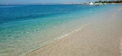 a beach with clear blue water and a rocky shore at EcoStay - Infinity business class 2BDR apartment by the sea in Alimos in Athens