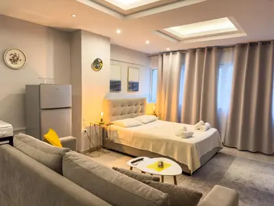 a bedroom with a bed and a couch at Glamorous & Spacious Renovated Apartment, Syntagma, DT Athens in Athens