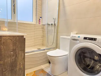a bathroom with a toilet and a washing machine at Glamorous & Spacious Renovated Apartment, Syntagma, DT Athens in Athens