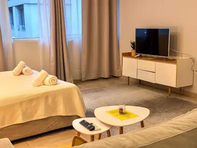 a living room with two beds and a tv at Glamorous & Spacious Renovated Apartment, Syntagma, DT Athens in Athens
