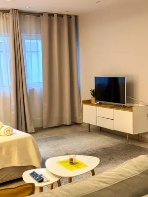 a living room with a flat screen tv on a cabinet at Glamorous & Spacious Renovated Apartment, Syntagma, DT Athens in Athens