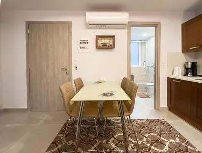 a kitchen and dining room with a table and chairs at Glamorous & Spacious Renovated Apartment, Syntagma, DT Athens in Athens