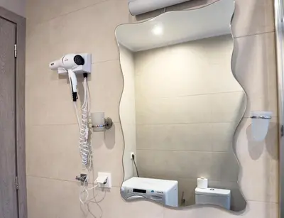 a bathroom with a hair dryer and a mirror at Glamorous & Spacious Renovated Apartment, Syntagma, DT Athens in Athens