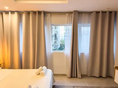 a bedroom with tan curtains and a window at Glamorous & Spacious Renovated Apartment, Syntagma, DT Athens in Athens