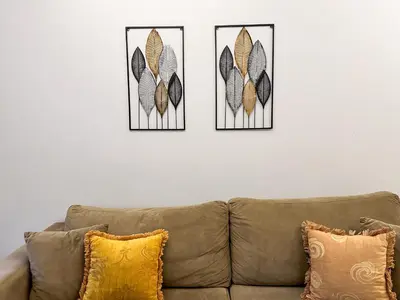 two pieces of art on a wall above a couch at Contemporary & Spacious Renovated Apartment, DT Syntagma, /Touristic Area in Athens