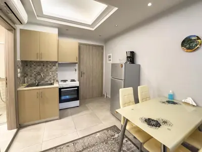 a kitchen with a table and a refrigerator at Contemporary & Spacious Renovated Apartment, DT Syntagma, /Touristic Area in Athens