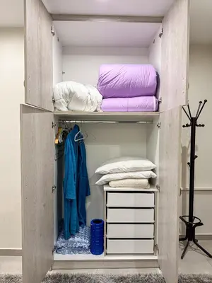 a wooden closet with pillows and blankets at Contemporary & Spacious Renovated Apartment, DT Syntagma, /Touristic Area in Athens