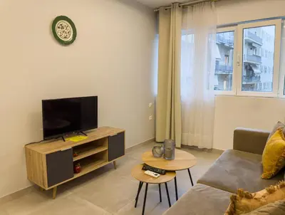 a living room with a couch and a tv at Contemporary & Spacious Renovated Apartment, DT Syntagma, /Touristic Area in Athens