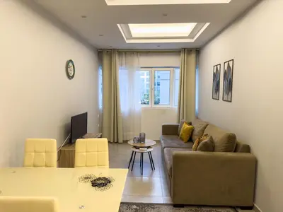 a living room with a couch and a table at Contemporary & Spacious Renovated Apartment, DT Syntagma, /Touristic Area in Athens