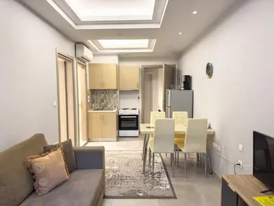 a living room with a couch and a table with chairs at Contemporary & Spacious Renovated Apartment, DT Syntagma, /Touristic Area in Athens