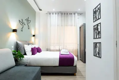 a bedroom with a large bed and a window at Romeo & Juliet In the heart of Athens in Athens