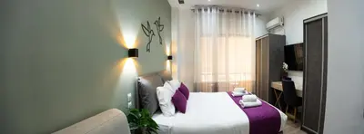 a bedroom with a bed and a couch at Romeo & Juliet In the heart of Athens in Athens