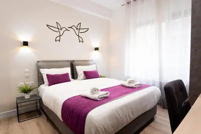 a bedroom with a large bed with towels on it at Romeo & Juliet In the heart of Athens in Athens