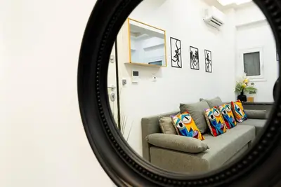 a mirror reflecting a couch in a living room at Romeo & Juliet In the heart of Athens in Athens