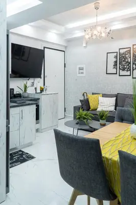 a living room with a table and a couch at King Davids Suite Athens finest! in Athens