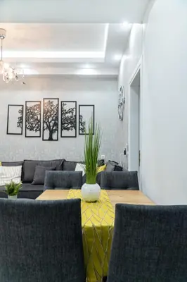 a dining room with a table and chairs and a couch at King Davids Suite Athens finest! in Athens
