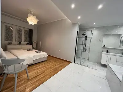a bedroom with a bed and a shower in it at Acropolis Casa 2bdr/2bthr w/hot tub-3mins to plaka in Athens