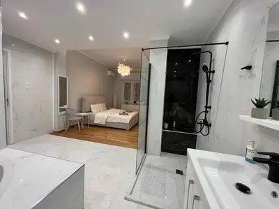 a bathroom with a shower and a bedroom with a bed at Acropolis Casa 2bdr/2bthr w/hot tub-3mins to plaka in Athens