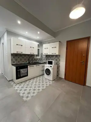 a kitchen with a stove and a microwave at Acropolis Casa 2bdr/2bthr w/hot tub-3mins to plaka in Athens