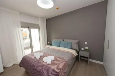 a bedroom with a bed with two pillows on it at Brand-new flat with a city view (FORM_G1) in Athens