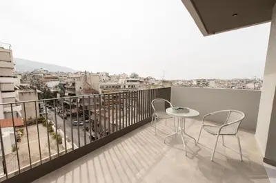 a balcony with a table and chairs and a view at Brand-new flat with a city view (FORM_G1) in Athens