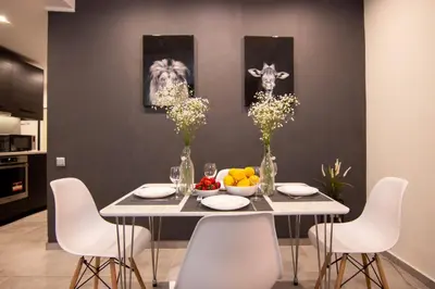 a dining room with a table with a bowl of fruit at 15 minutes from Acropolis apartment in Athens