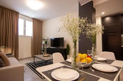 a living room with a table with plates and vases at 15 minutes from Acropolis apartment in Athens
