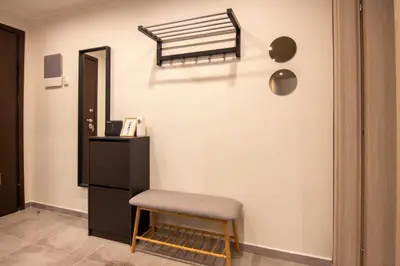 a room with a chair and a black cabinet at 15 minutes from Acropolis apartment in Athens