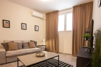 a living room with a couch and a table at 15 minutes from Acropolis apartment in Athens