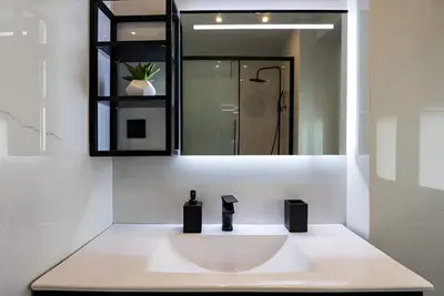 a bathroom with a white sink and a mirror at Paradise Syntagma Family Apartment in Athens