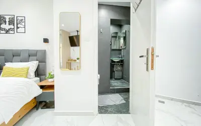 a bedroom with a bed and a mirror at Paradise Syntagma Family Apartment in Athens