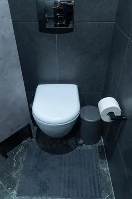 a bathroom with a white toilet and a trash can at Paradise Syntagma Family Apartment in Athens