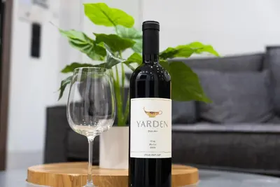 a bottle of wine next to a wine glass at Paradise Syntagma Family Apartment in Athens