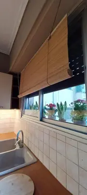 a kitchen with a sink and a window with potted plants at 115m2 K.G HOME in Athens