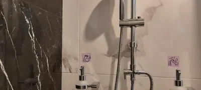 a bathroom with a shower and a sink with a faucet at Taratsaki in Athens