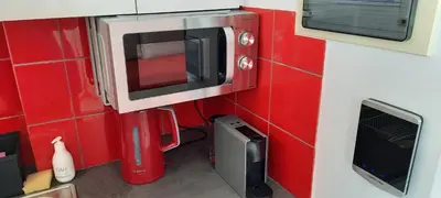 a small kitchen with a microwave and a toaster oven at Taratsaki in Athens