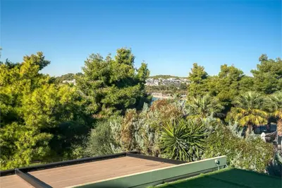 a roof of a house with trees in the background at South Blue Luxury Apartment in Vouliagmeni in Athens